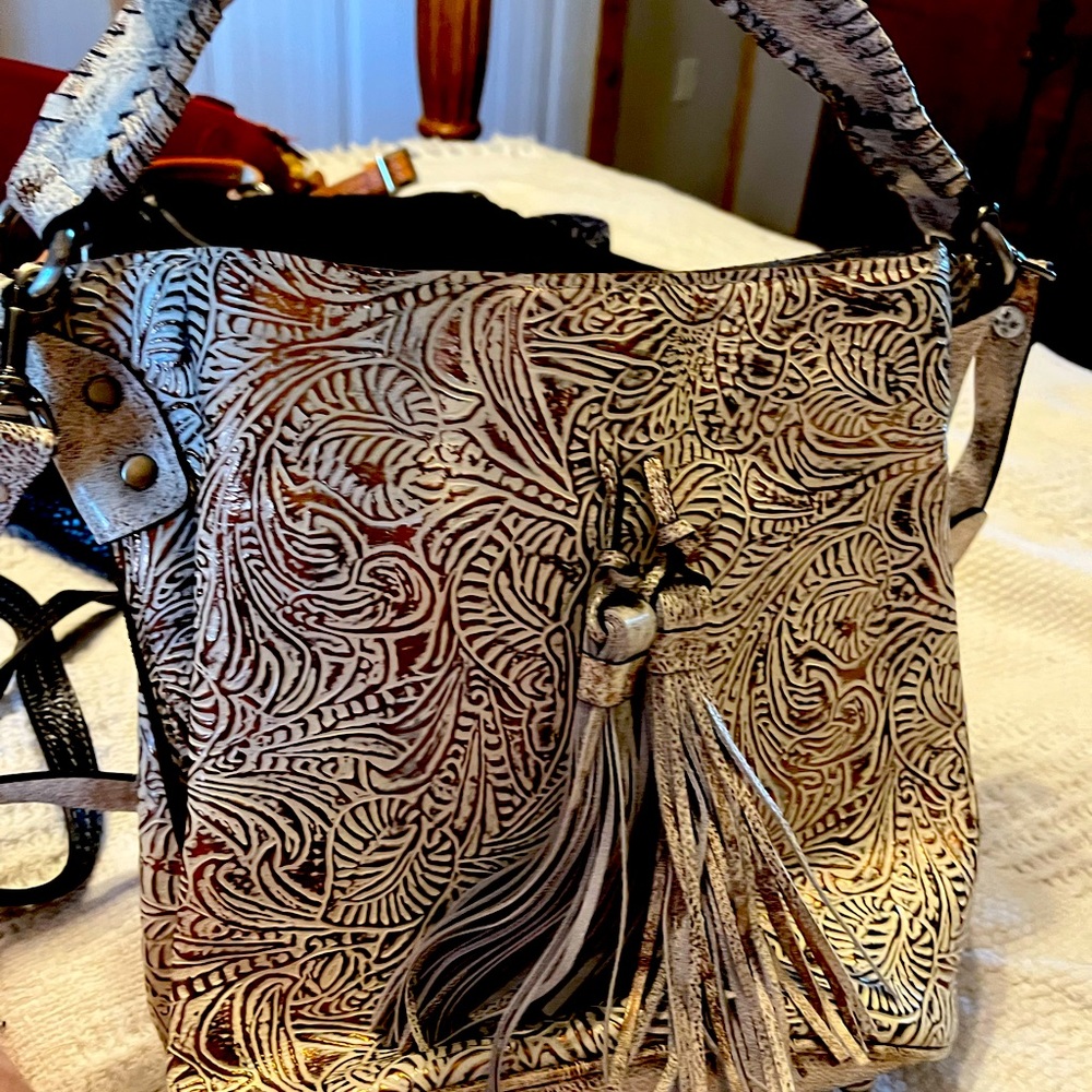 Bucket style purse with hand or shoulder strap. cream with brown/ gold accent